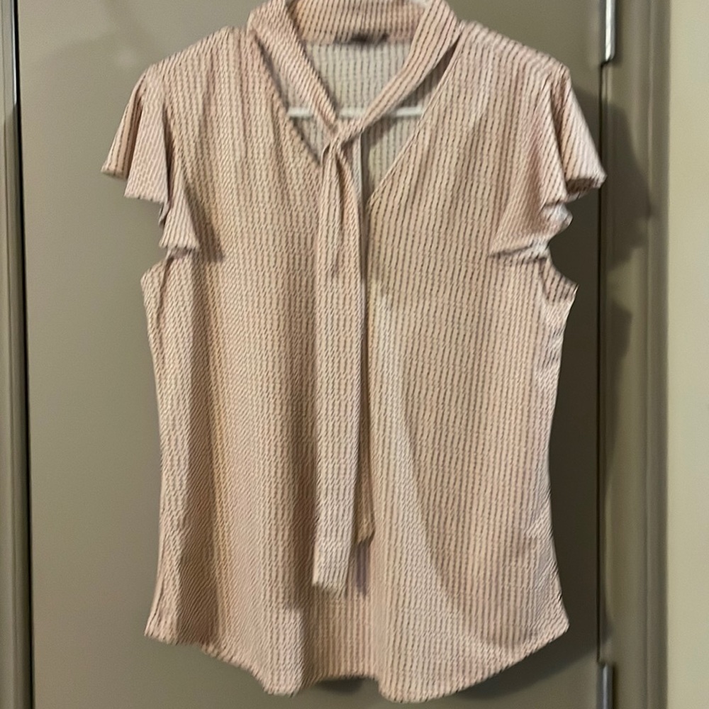 Five dollar sale. Polkadot, pink shirt with a tie detail.